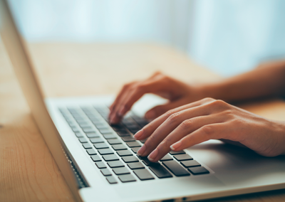 person typing on a laptop